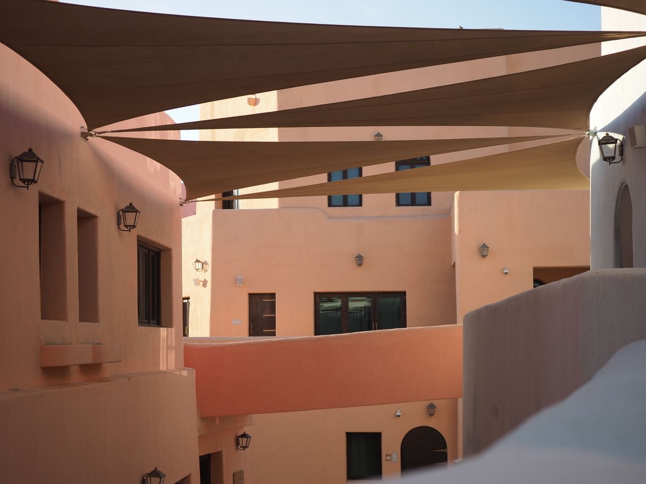 Geometric architecture with bold colors and clean lines in a sunny Doha setting.